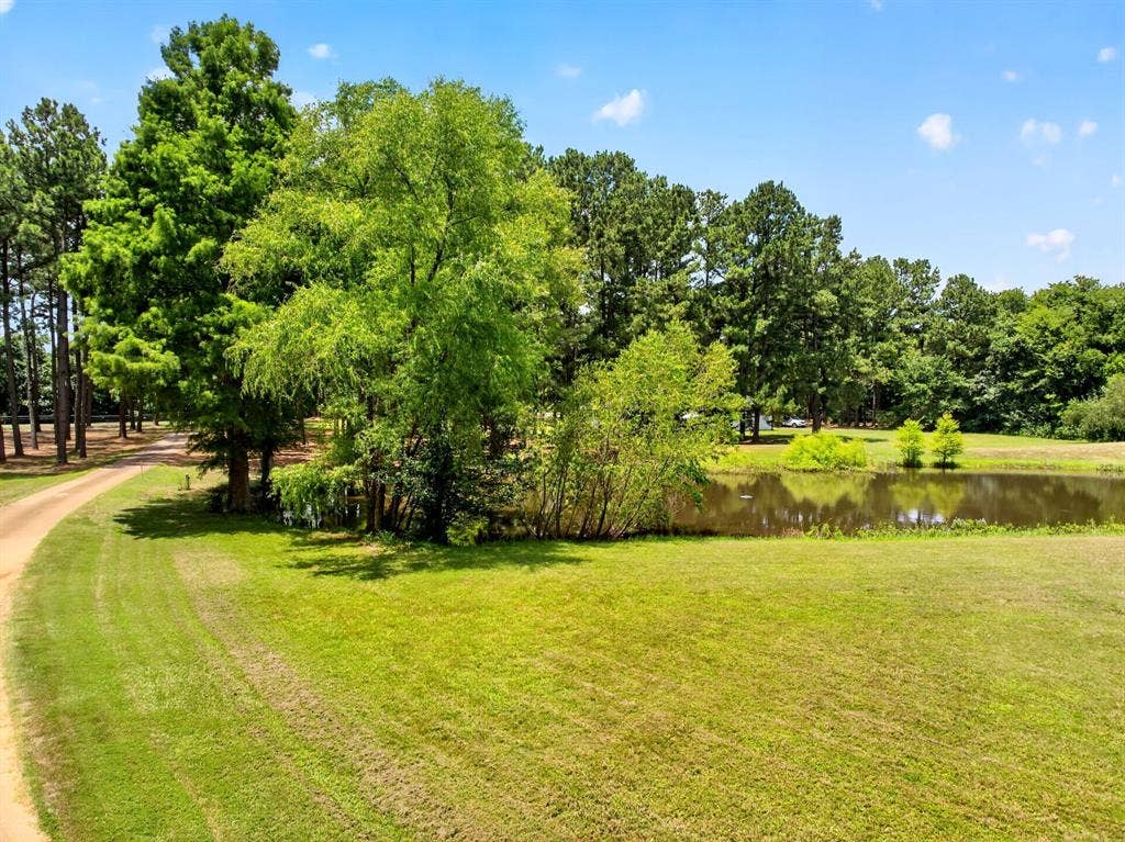 1201 Robbins Road, Athens, TX 75751 Stocked Pond- Fish food can be found in the kitchen, kids & adults alike will enjoy feeding the fish while touring your new home.