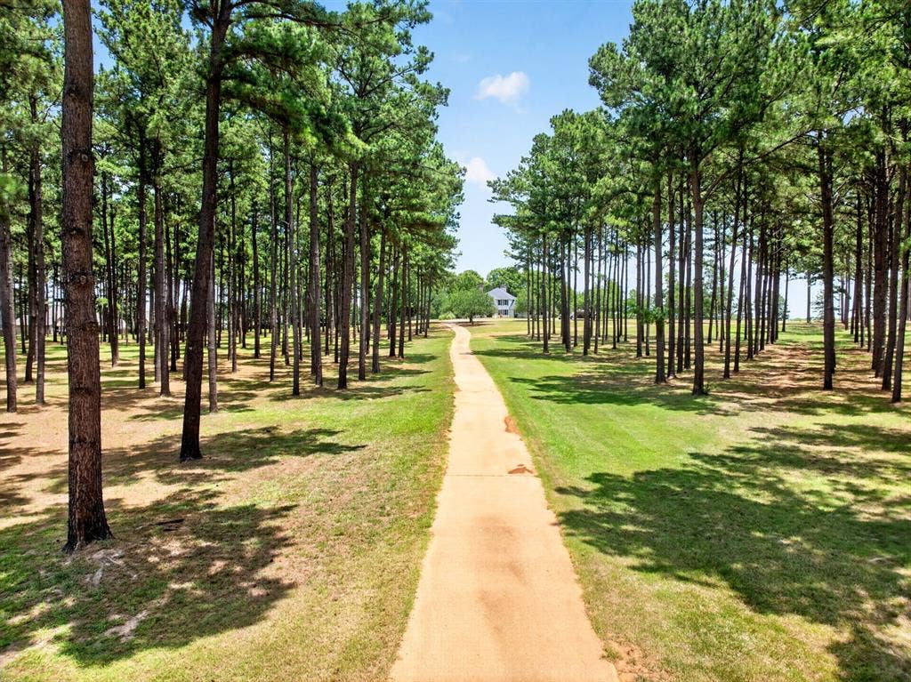 1201 Robbins Road, Athens, TX 75751 Welcome to 1201 Robbins Road. Upon arriving at the gated entrance, you're greeted with mature pine trees towering the private concrete driveway.