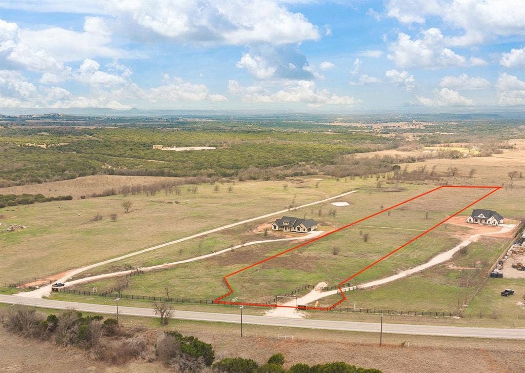 12701 W FM 4, Godley, TX 76044 Expansive parcel featuring a rural setting, a paved road frontage, and a defined property boundary