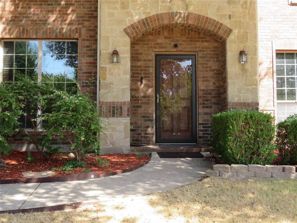 1122 Walter Stephenson Road, Midlothian, TX 76065 Brick and stone facade featuring an arched entryway