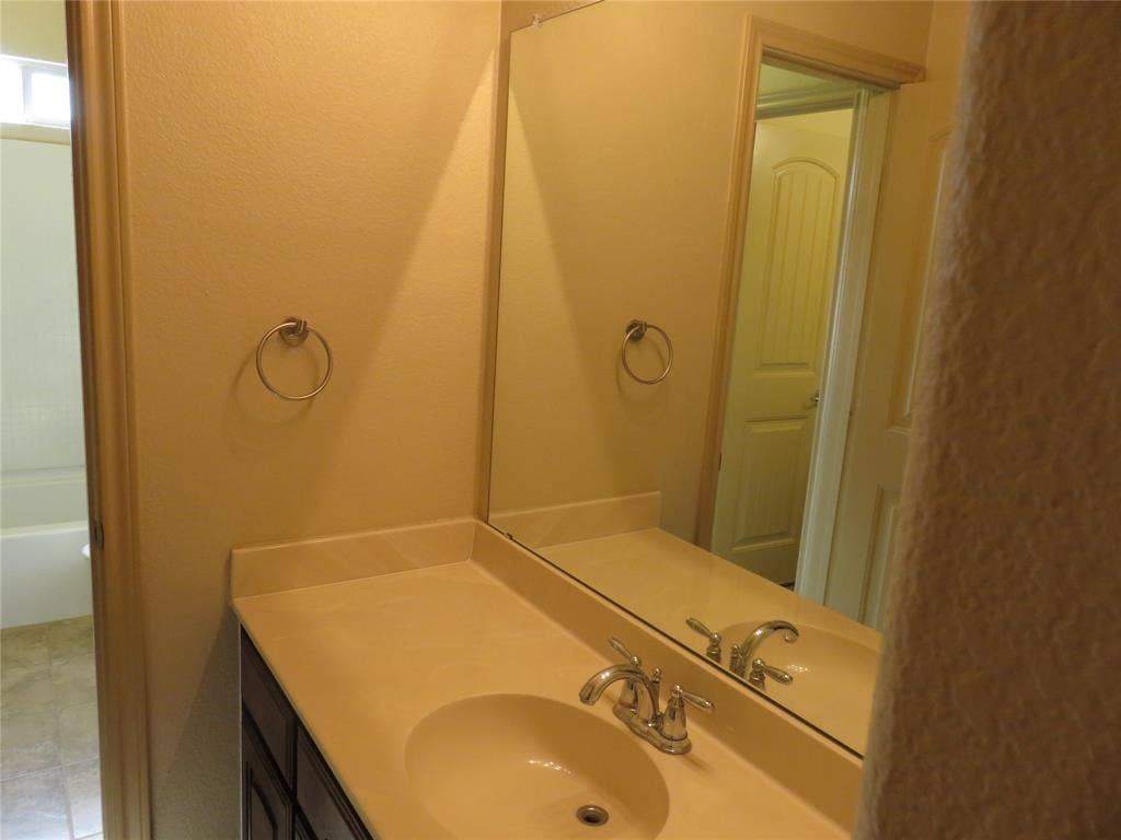1122 Walter Stephenson Road, Midlothian, TX 76065 Vanity with integrated sink, chrome faucet, and expansive wall-mounted mirror