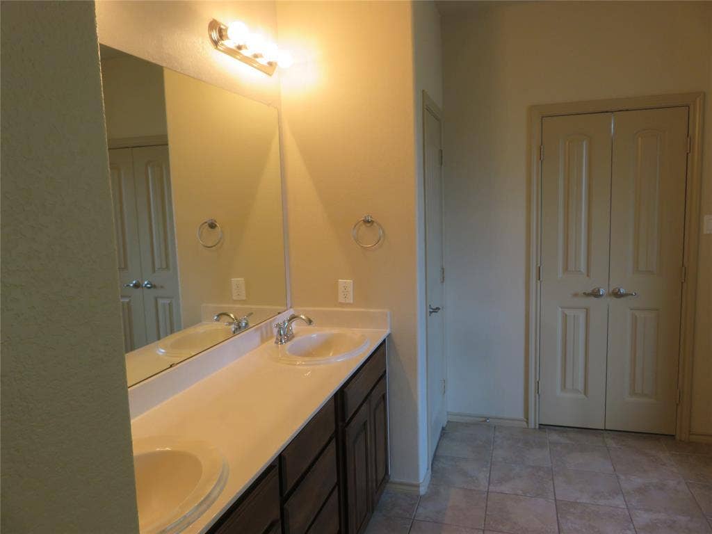 1122 Walter Stephenson Road, Midlothian, TX 76065 Double vanity featuring undermount sinks, chrome faucets, and a light-toned countertop