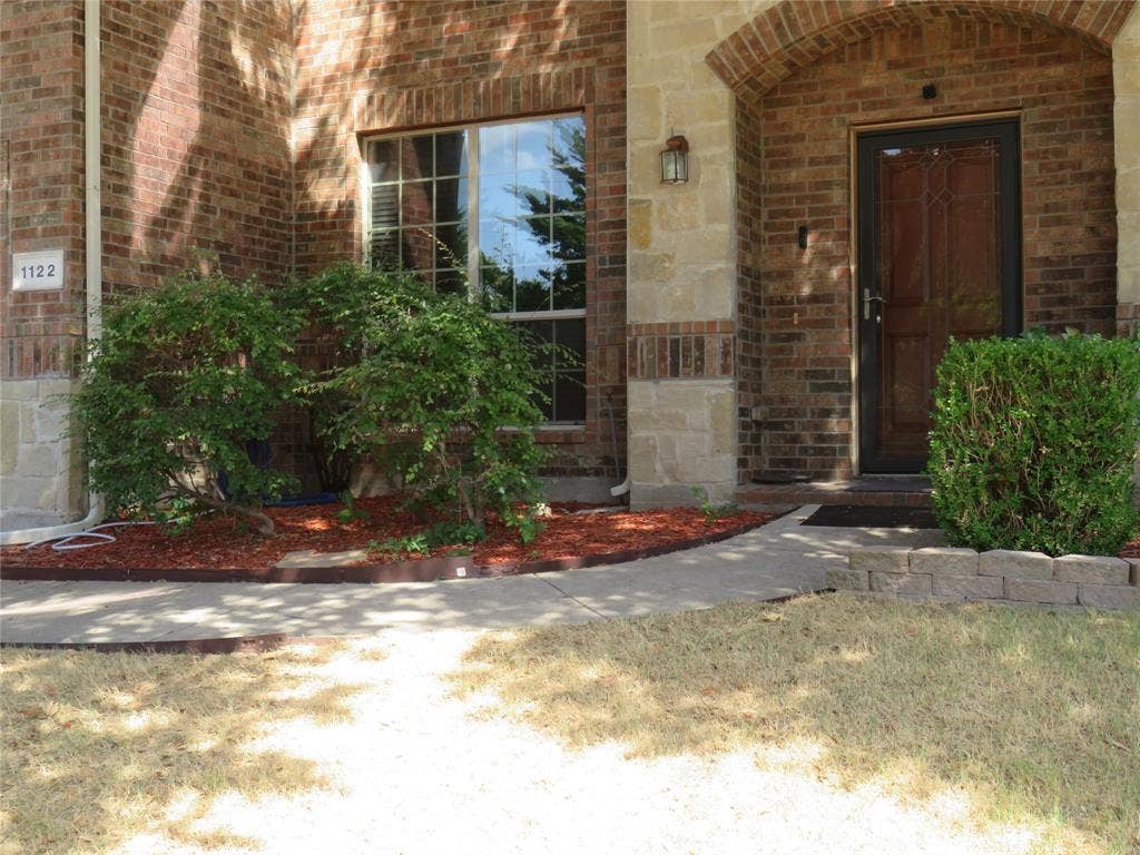 1122 Walter Stephenson Road, Midlothian, TX 76065 Brick and stone facade with an arched entryway