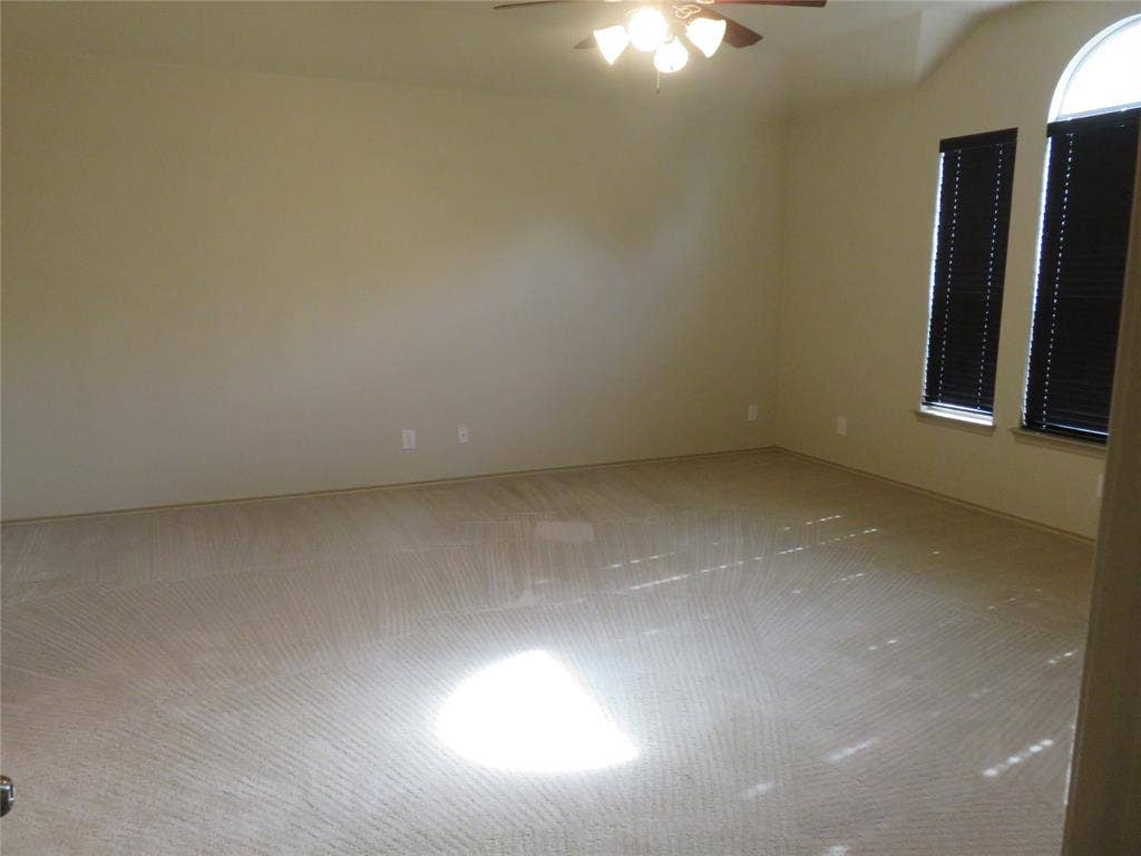 1122 Walter Stephenson Road, Midlothian, TX 76065 Spacious room featuring neutral carpet flooring, light-colored walls, and a ceiling fan with integrated lighting