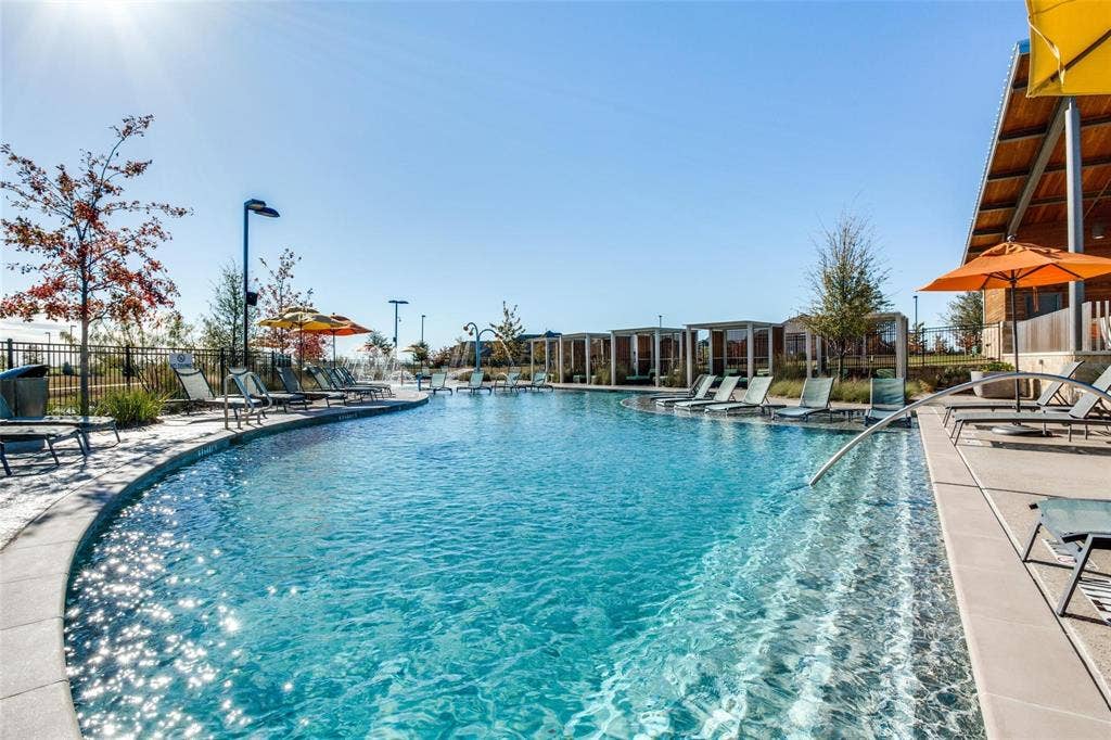 3861 Dalea Drive, Prosper, TX 75078 Resort-style aquatic amenity featuring a curved swimming pool with integrated entry steps and perimeter lounge seating