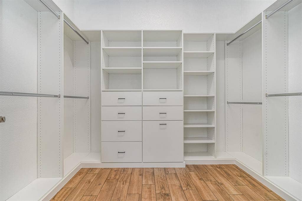 3861 Dalea Drive, Prosper, TX 75078 Custom white closet system featuring shelving, drawers, and hanging rods