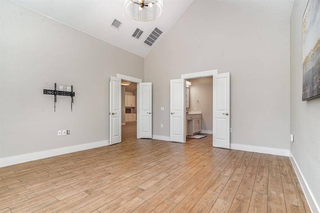 3861 Dalea Drive, Prosper, TX 75078 Primary Bedroom Vaulted ceilings enhancing the spacious interior, complemented by light wood-finish flooring