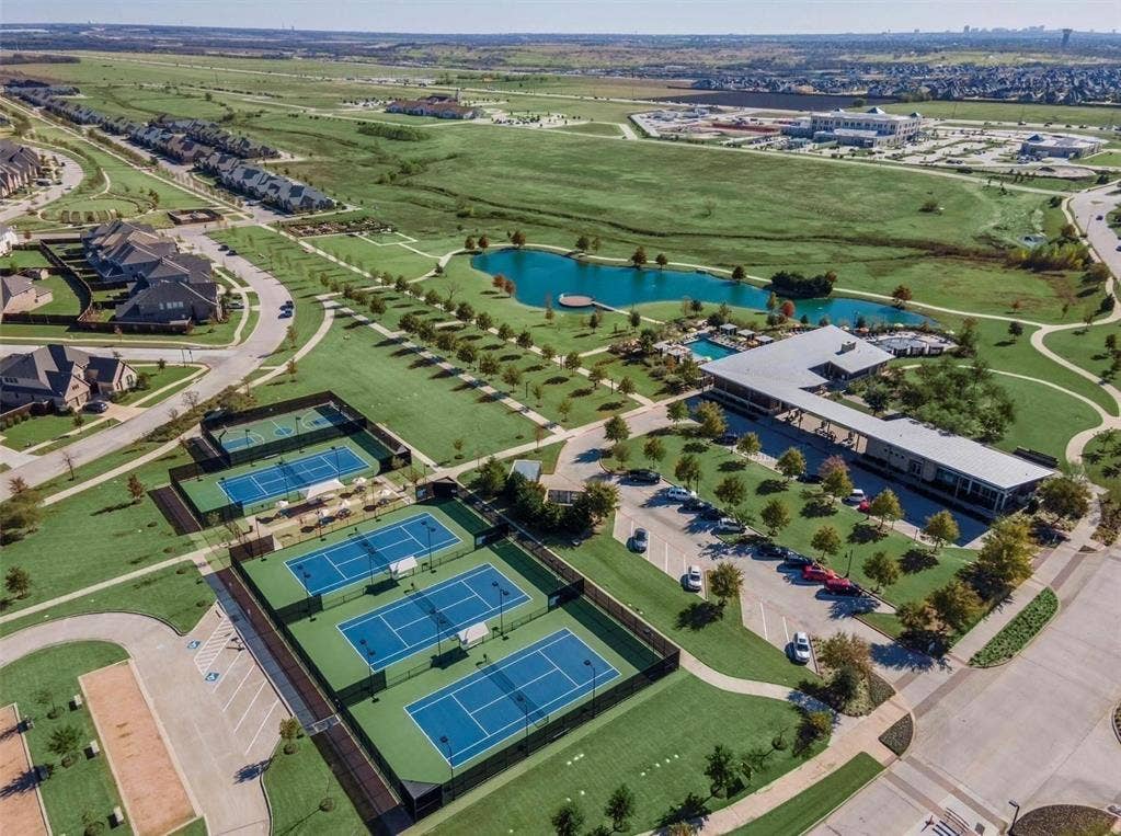 3861 Dalea Drive, Prosper, TX 75078 Aerial perspective showcasing multiple tennis courts, a recreational building, and a serene pond