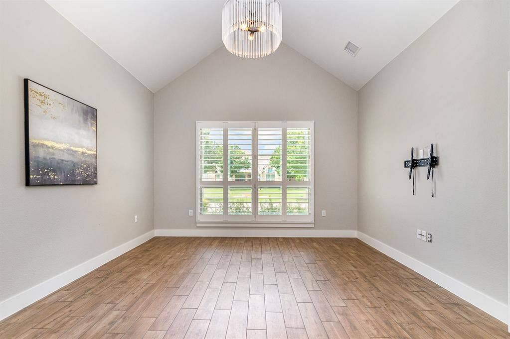 3861 Dalea Drive, Prosper, TX 75078 Primary Bedroom Vaulted ceilings enhancing the spacious interior, complemented by light wood-finish flooring
