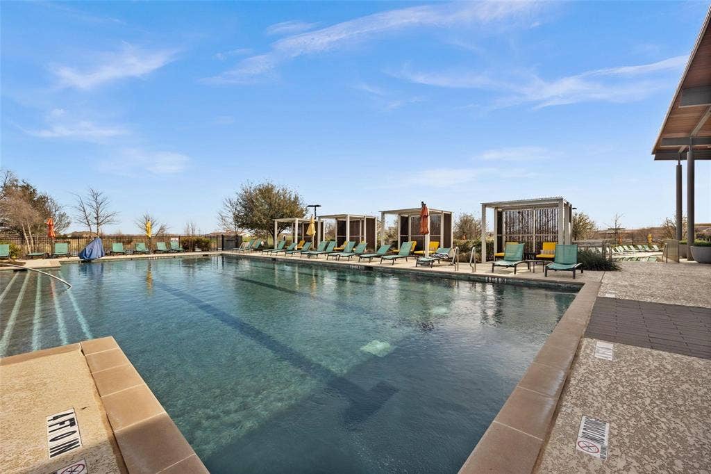 3861 Dalea Drive, Prosper, TX 75078 Resort-style pool area featuring a large swimming pool, multiple poolside cabanas, and an expansive paved deck