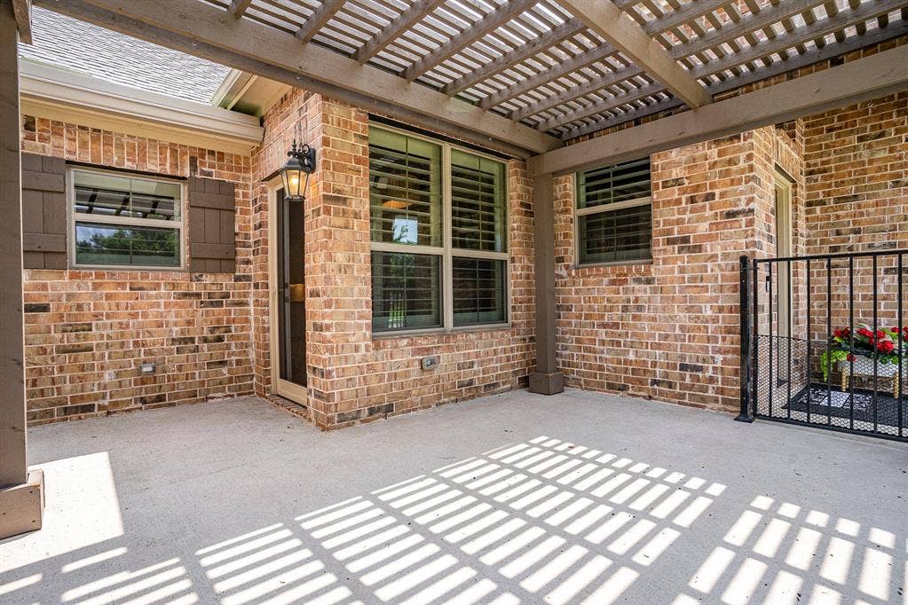 3861 Dalea Drive, Prosper, TX 75078 Expansive outdoor front patio with concrete flooring, accented by a wood pergola