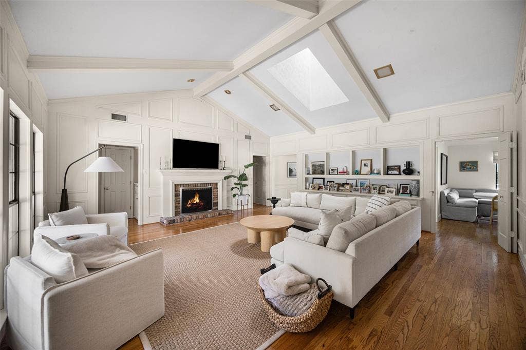 6501 Copper Creek Drive, Dallas, TX 75248 Spacious living area featuring a vaulted ceiling with exposed beams, skylight, and recessed lighting