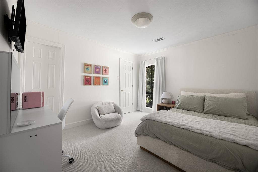 6501 Copper Creek Drive, Dallas, TX 75248 Spacious bedroom featuring light-colored carpeting, white painted walls, and a large window with white curtains