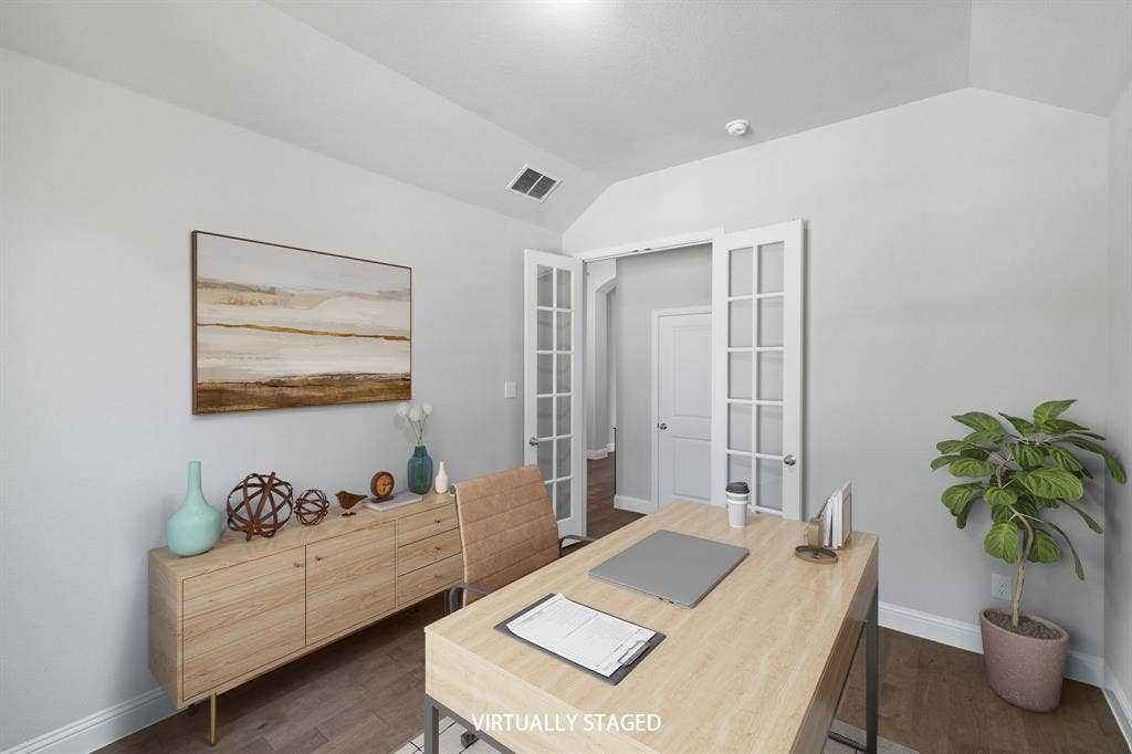 Generous sized office or 5th bedroom at the front of the home. Virtually staged photo.