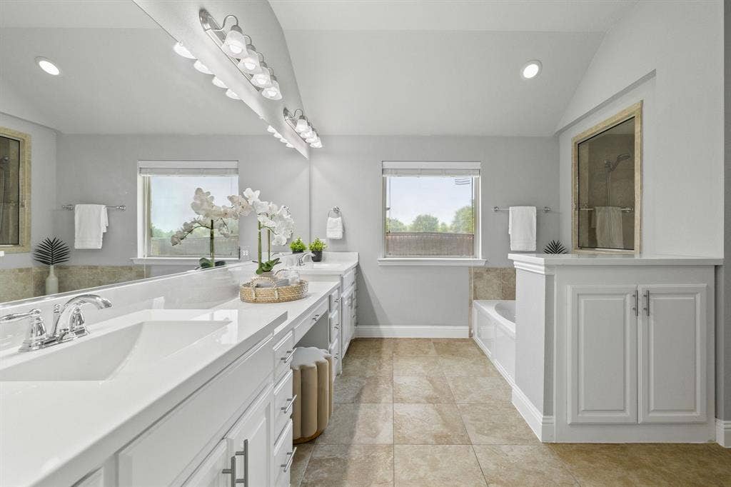 Spacious master bathroom with dual walk-in closets.