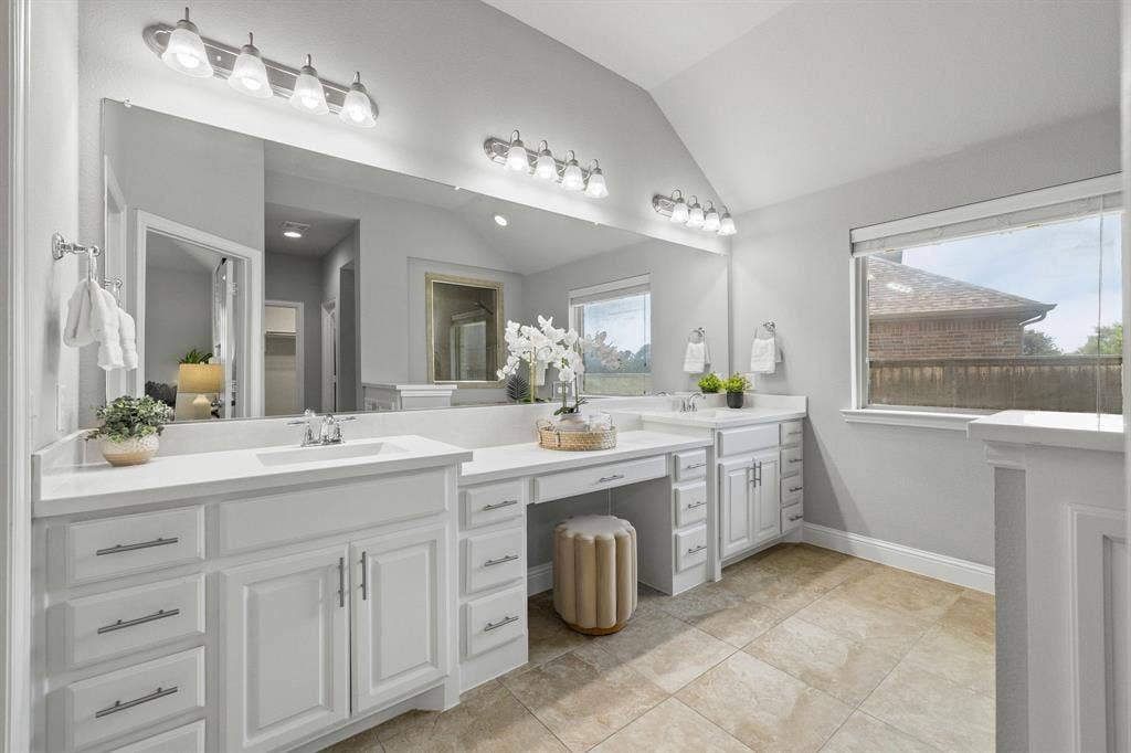 Spacious master bathroom with dual walk-in closets.