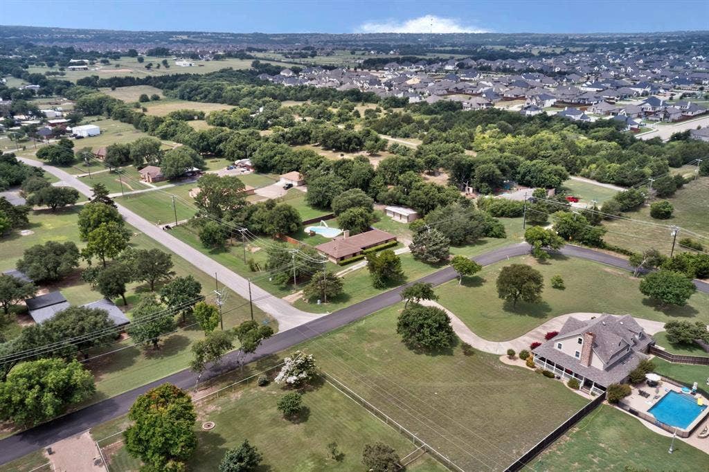 Expansive aerial view showcasing residential properties amidst abundant mature trees