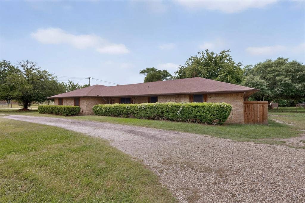 Single-story brick exterior with a brown shingle roof