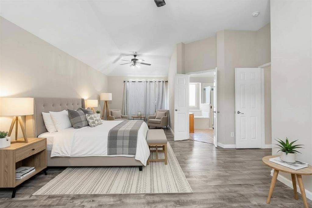 1013 Larkspur Drive, Allen, TX 75002 Spacious bedroom featuring wood-finish flooring, a ceiling fan with integrated lighting, and a recessed sitting area