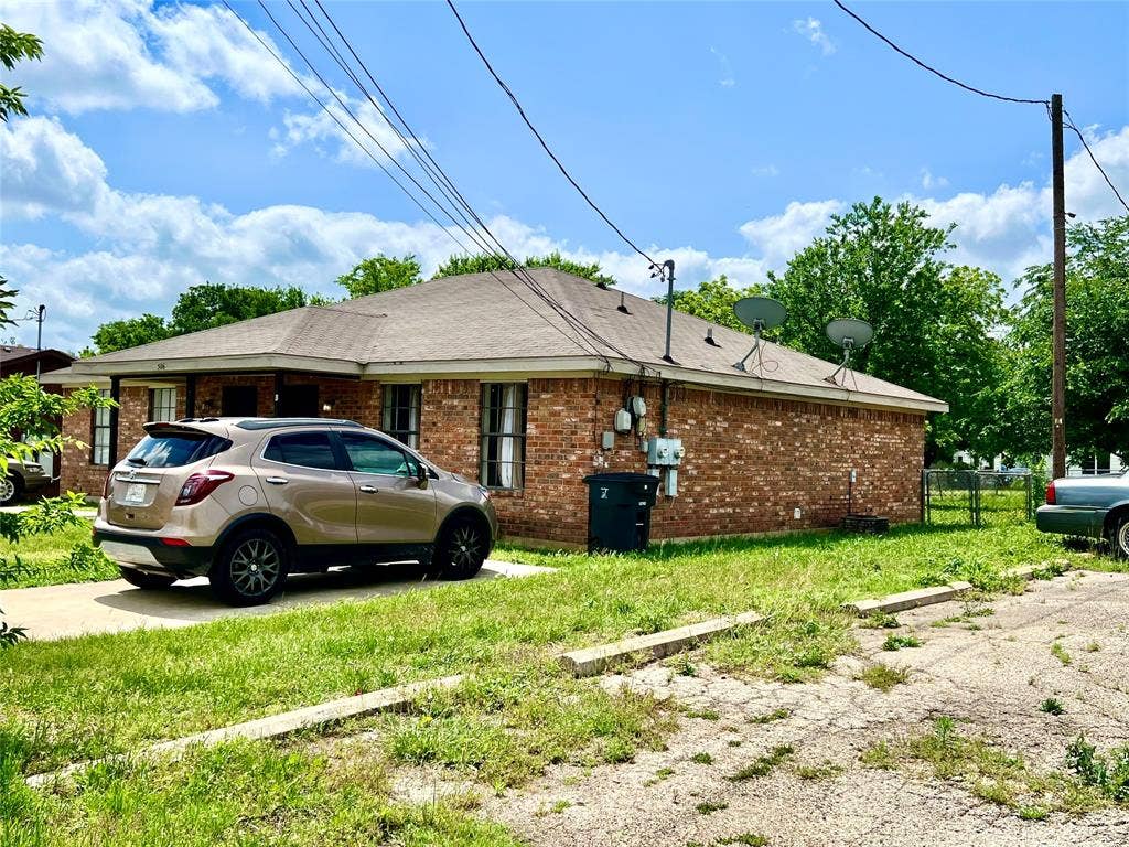 506 W Green Avenue, Killeen, TX 76541 View of property exterior with brick siding and a shingled roof