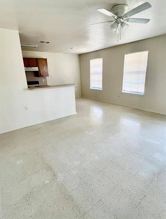 506 W Green Avenue, Killeen, TX 76541 Unfurnished living room with light flooring and a textured ceiling