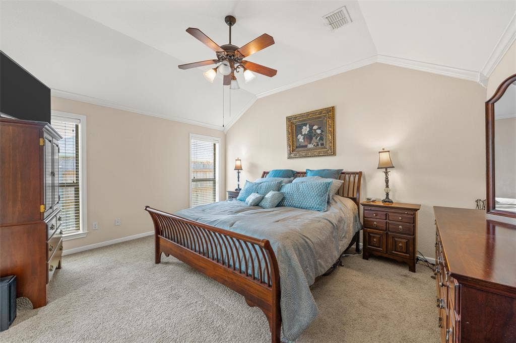 Bedroom featuring a vaulted ceiling and a ceiling fan with integrated lighting