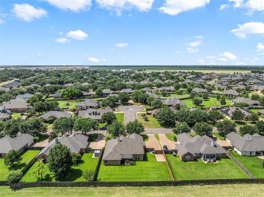 Expansive residential community featuring a variety of single-story homes with mature trees and manicured lawns