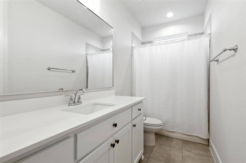 3141 Claire Drive, Midlothian, TX 76065 Bathroom featuring a white vanity with an integrated sink, chrome faucet, and matte black cabinet pulls