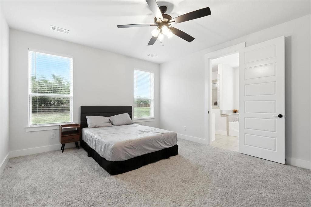 3141 Claire Drive, Midlothian, TX 76065 Carpeted room featuring a ceiling fan with integrated lighting, two windows with blinds, and a five-panel interior door
