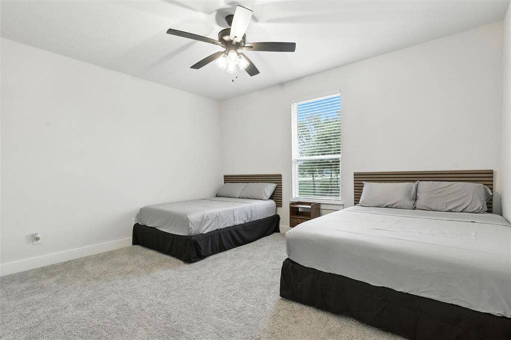 3141 Claire Drive, Midlothian, TX 76065 Bright room featuring a window with horizontal blinds, a ceiling fan with integrated lighting, and light-toned wall-to-wall carpeting