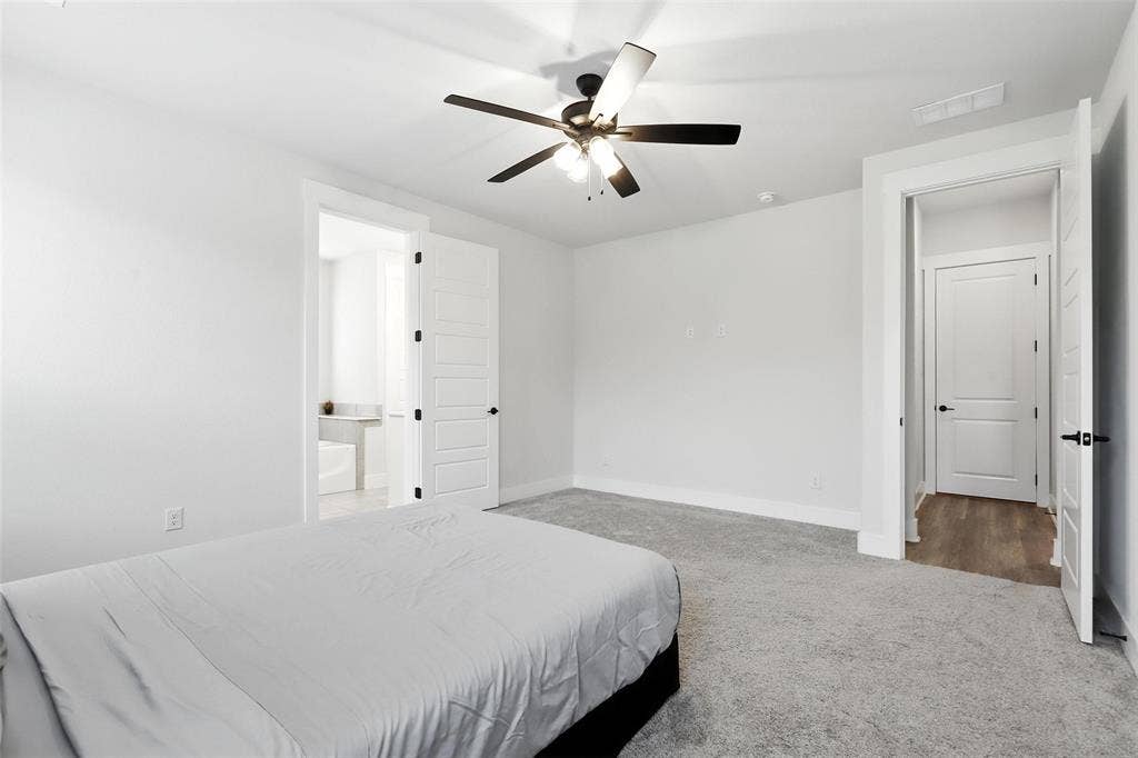 3141 Claire Drive, Midlothian, TX 76065 Carpeted bedroom featuring white walls, a ceiling fan with integrated lighting, and white paneled doors with matte black hardware