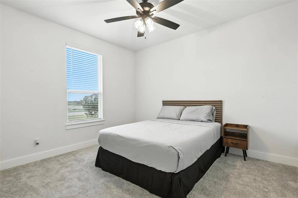 3141 Claire Drive, Midlothian, TX 76065 Bedroom featuring a ceiling fan with integrated lighting, a large window with blinds, and light-colored carpeting
