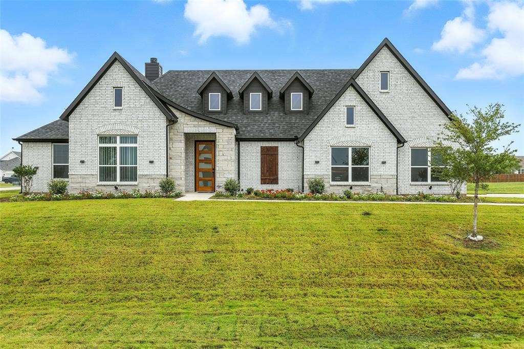 3141 Claire Drive, Midlothian, TX 76065 Contemporary home with a stone and light brick exterior, prominent gables, and dormer windows