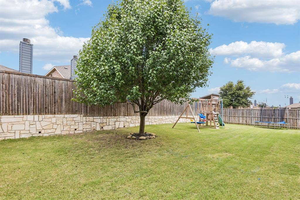3500 Brazos Street, Melissa, TX 75454 well maintained yard with stone retaining wall