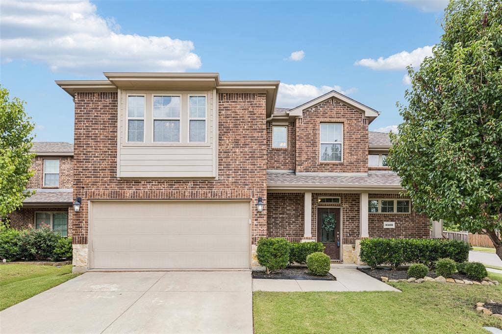 3500 Brazos Street, Melissa, TX 75454 Brick facade residence with a two-car garage, covered porch entry, and a prominent bay window feature