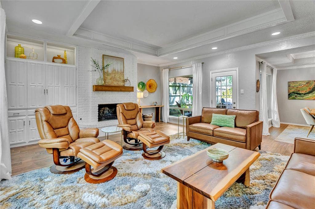 1830 Rhinevalley Drive, Arlington, TX 76012 Wood burning fireplace with the TV section behind the built in cabinetry