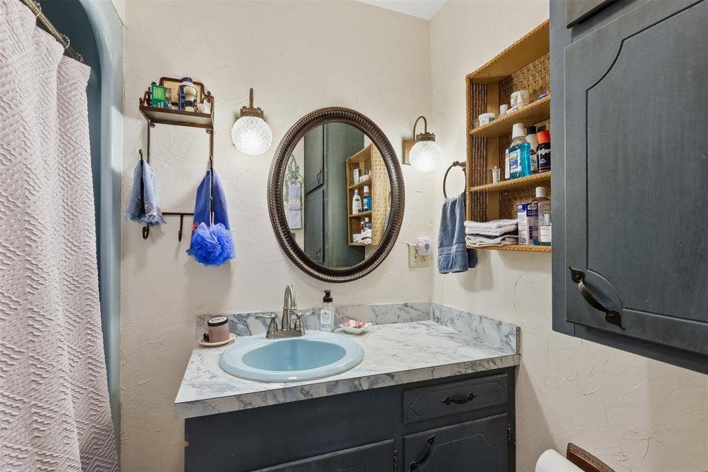 777 Wildwood Trail, Weatherford, TX 76085 Bathroom featuring a blue vanity with a white countertop and a light blue basin