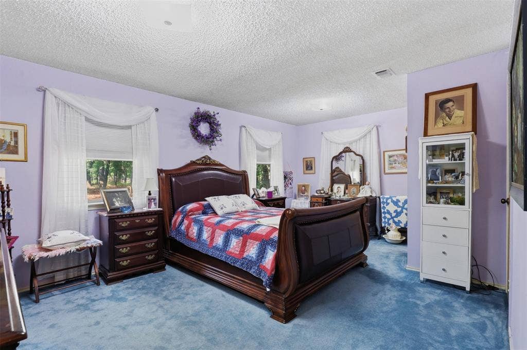 777 Wildwood Trail, Weatherford, TX 76085 Interior room with light lavender walls, blue carpeting, and multiple windows