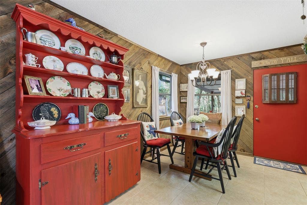 777 Wildwood Trail, Weatherford, TX 76085 Dining area featuring wood-paneled walls and neutral-toned floor tile