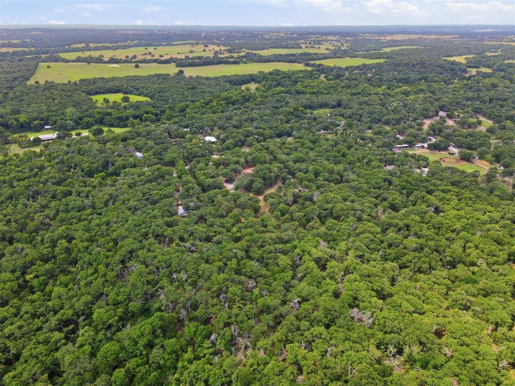 777 Wildwood Trail, Weatherford, TX 76085 Expansive property featuring dense tree coverage and surrounding open fields