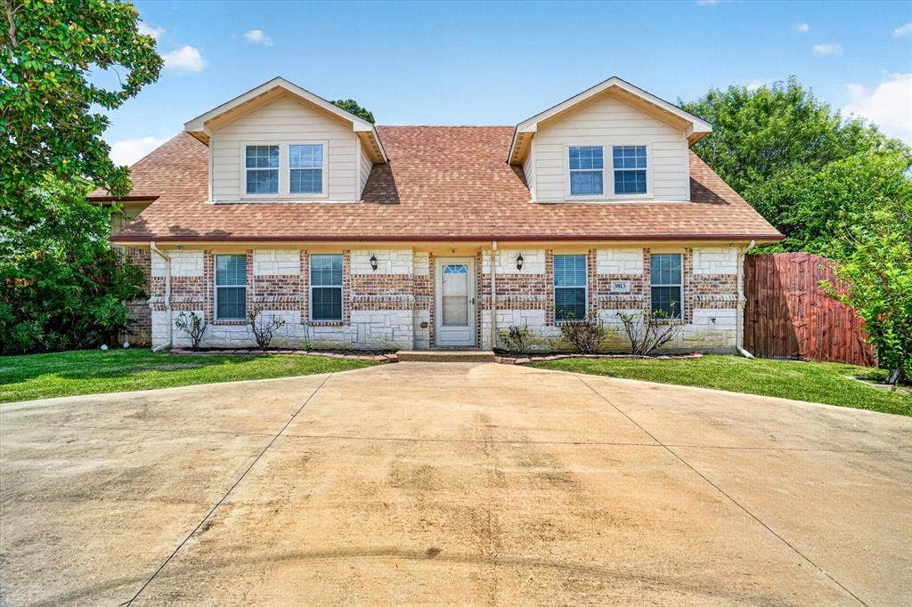Beautiful accent brick and stone compliment the front view of the home.