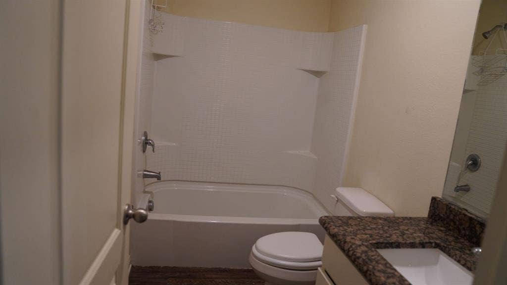1321 Eagle Lake Drive, Azle, TX 76020 Bathroom featuring a shower/tub combination, vanity with countertop, and wood-finish flooring