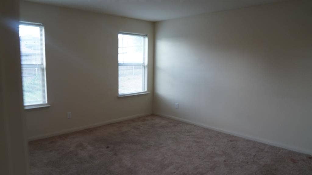 1321 Eagle Lake Drive, Azle, TX 76020 Carpeted room with two windows featuring blinds