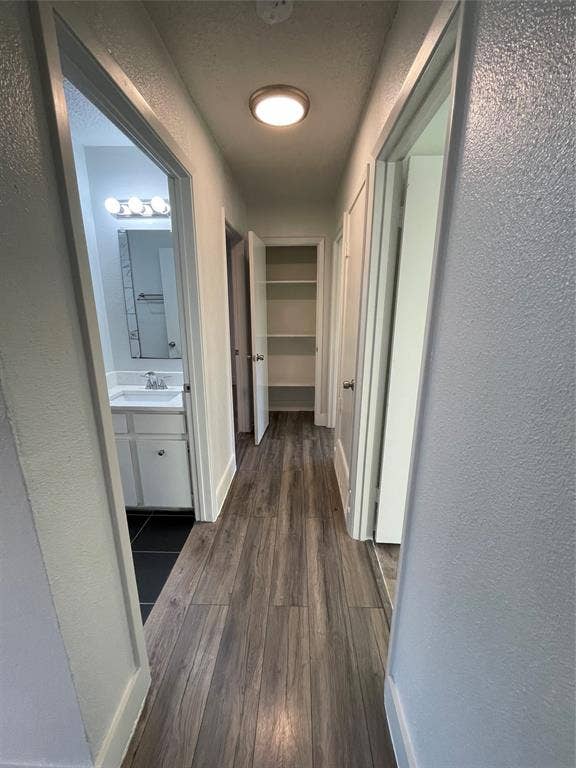 822 Johnnie Row, Seagoville, TX 75159 Hall with dark wood-type flooring and sink