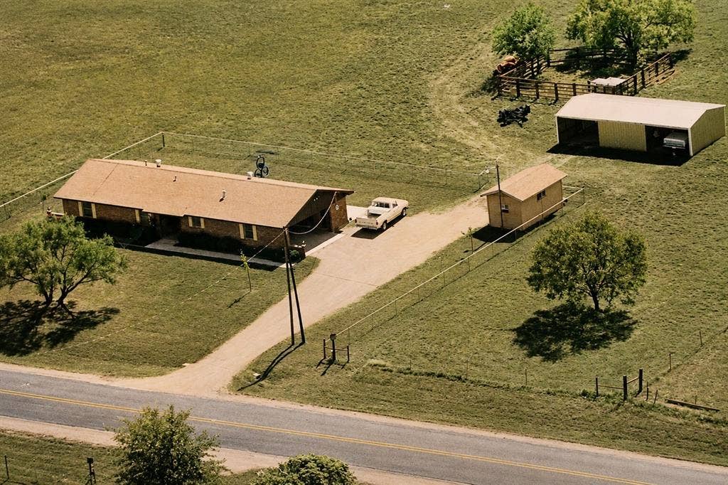 8769 S Fm 148, Scurry, TX 75158 Picture is from the 1980's! Ranch-style residence featuring a brick exterior and a brown shingle roof