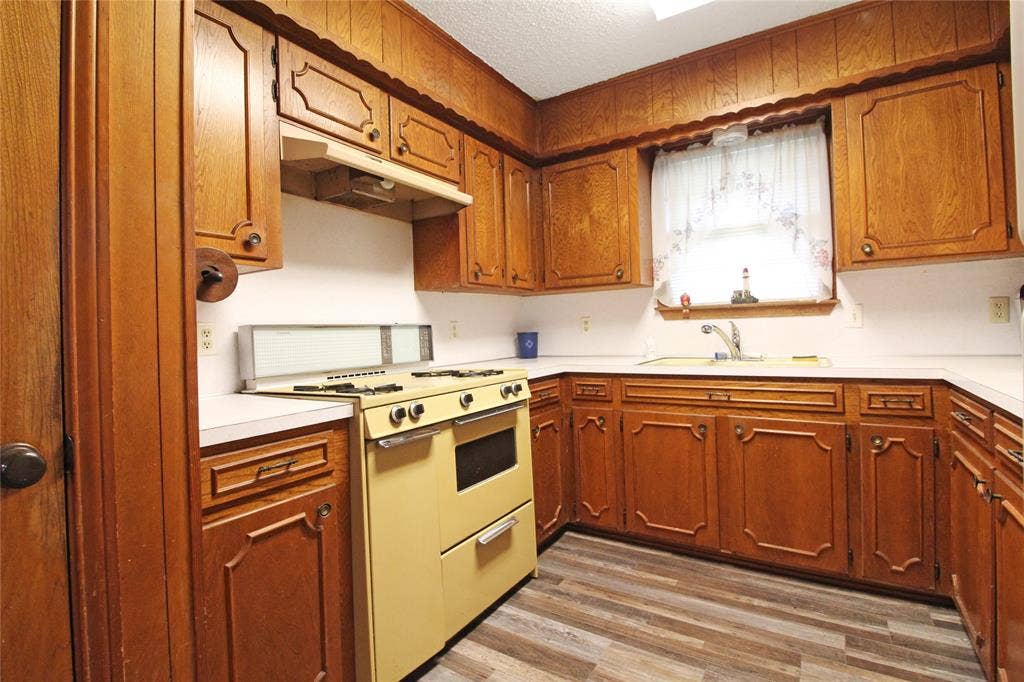 8769 S Fm 148, Scurry, TX 75158 Kitchen featuring wood cabinetry, white countertops, built-in sink, and wood-finish flooring