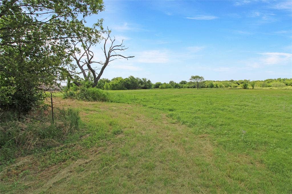 8769 S Fm 148, Scurry, TX 75158 Expansive open field under a clear sky
