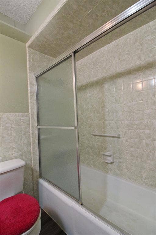 8769 S Fm 148, Scurry, TX 75158 Bathtub with sliding glass shower doors and tiled surround