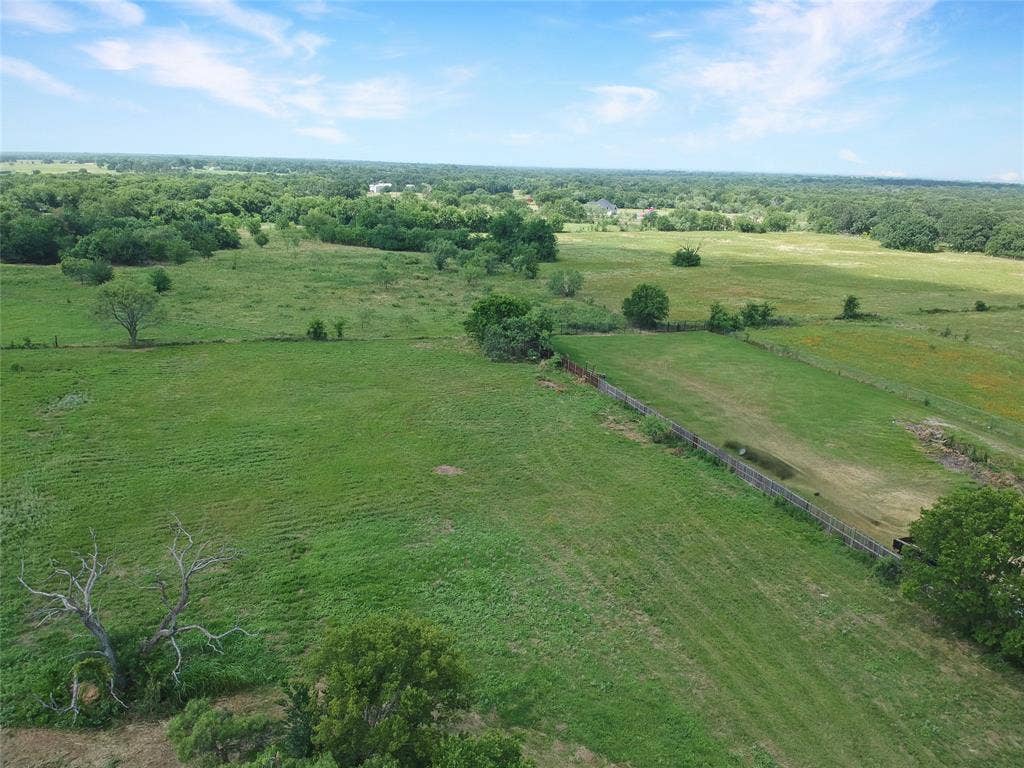 8769 S Fm 148, Scurry, TX 75158 Expansive green pastures featuring mature trees and a partial fence line