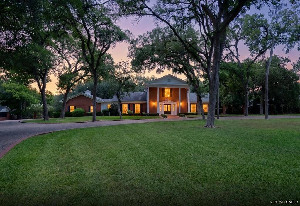 2825 Lake Air Drive, Waco, TX 76710 Brick exterior with a grand portico featuring white columns, a meticulously maintained lawn, mature trees, and a curved paved driveway